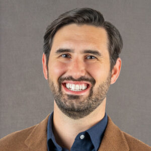 Portrait of Andrew Calkins looking at the camera and smiling
