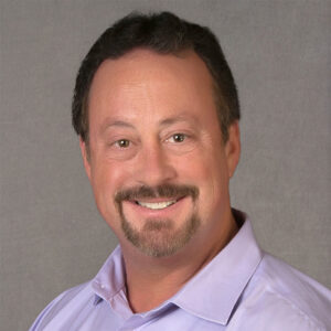 Portrait of Ken Kugler looking at the camera and smiling